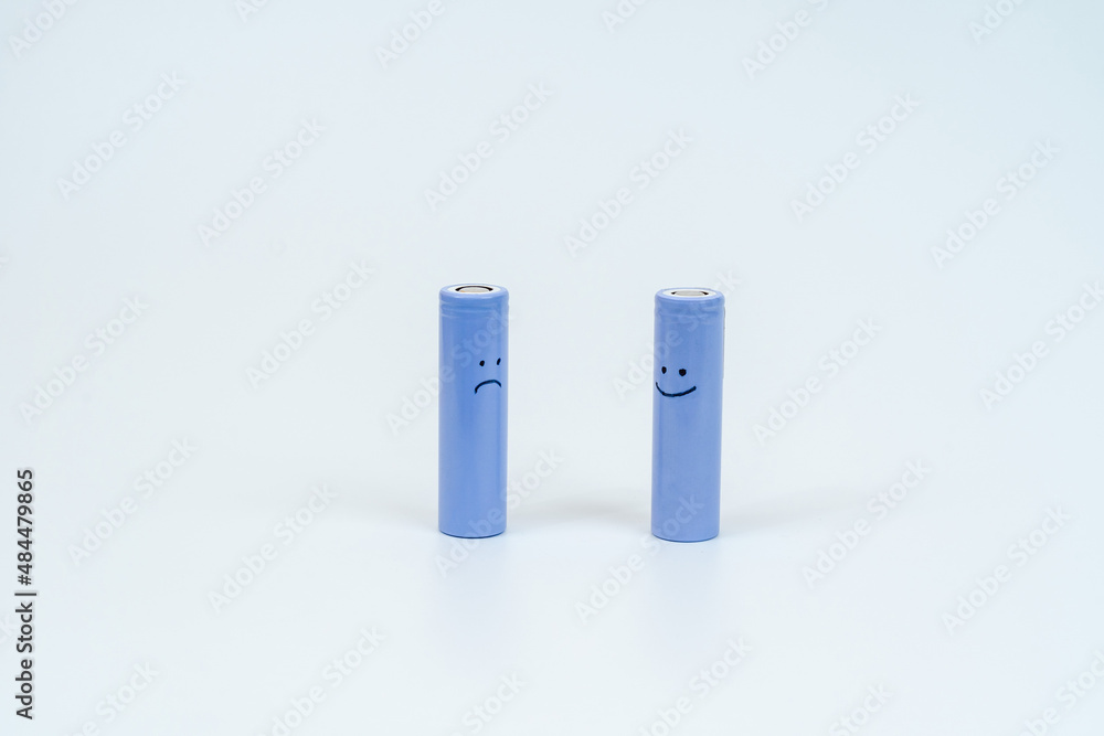 Energy battery 18650 with smiley isolated on white background Energy battery 18650 with smiley isolated on white background