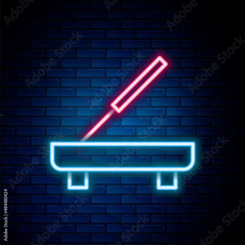 Glowing neon line Scented spa stick on a wooden stand icon isolated on brick wall background. Incense stick. Cosmetic procedure aromatherapy. Colorful outline concept. Vector