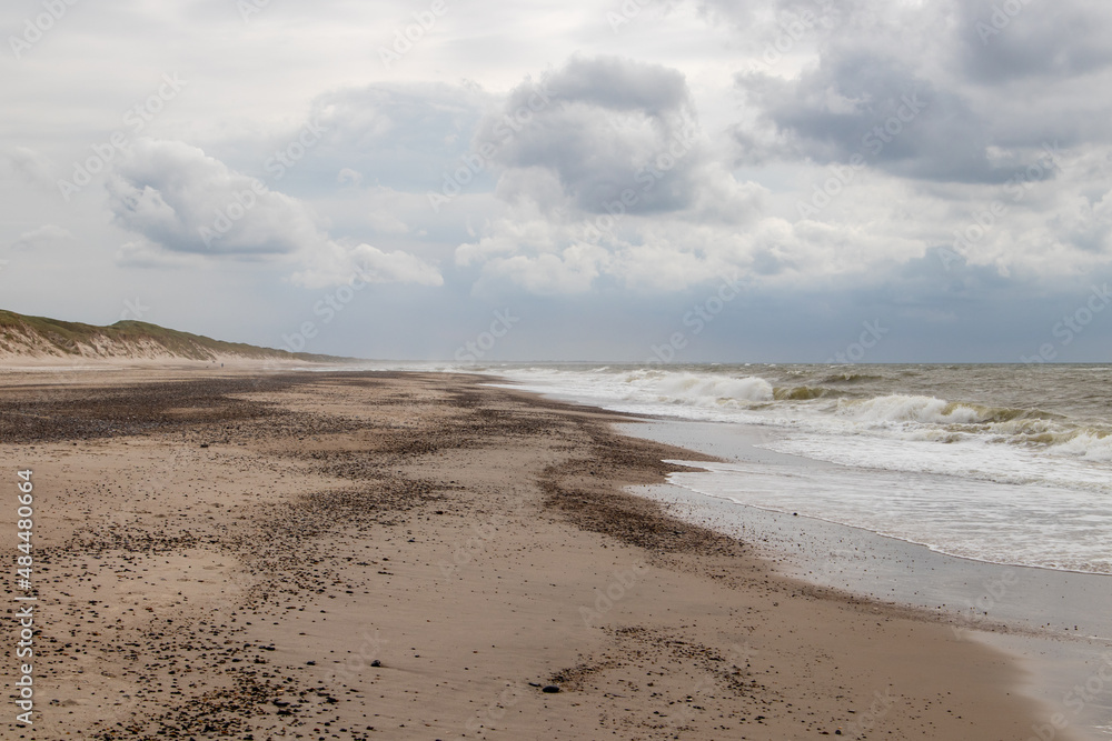 clouds over the beach at the north sea on a stormy day