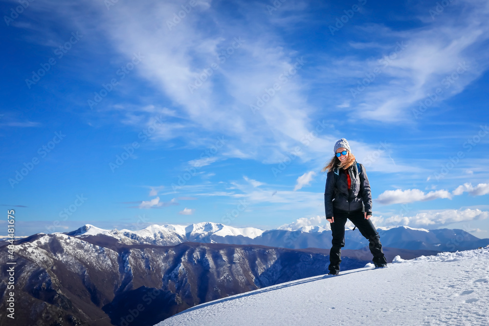 Portrait of girl on hike up the top of the snowy mountain.