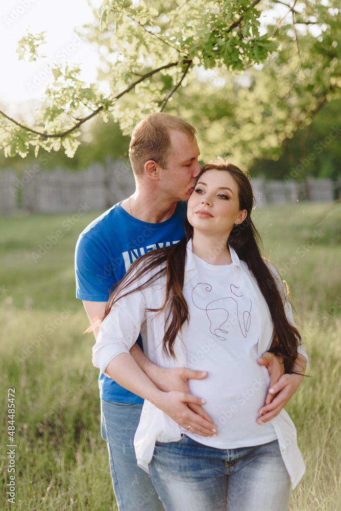 Young heterosexual pregnant couple in an outdoor park Young heterosexual pregnant couple in an outdoor park