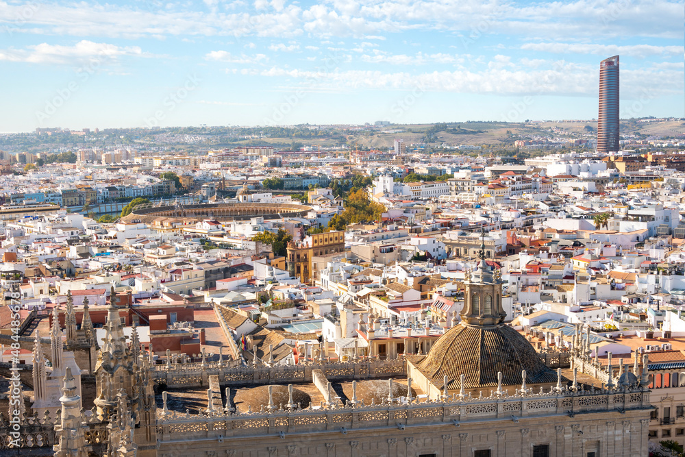 City view from the Giralda Tower of the Great Seville Cathedral of the Plaza de toros de la Real Maestranza Bullring and Sevilla or Pelli Tower in Seville, Spain.