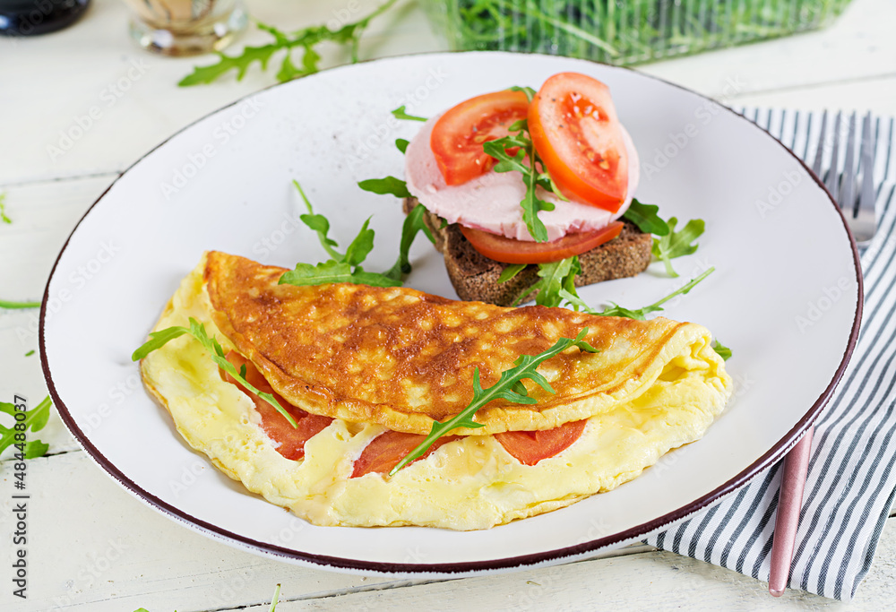 Breakfast. Omelette with tomatoes, cheese and sandwich with boiled sausage. Frittata - italian omelet. Breakfast. Omelette with tomatoes, cheese and sandwich with boiled sausage. Frittata - italian omelet.