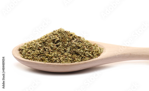Pile of dried oregano leaves in wooden spoon isolated on white 