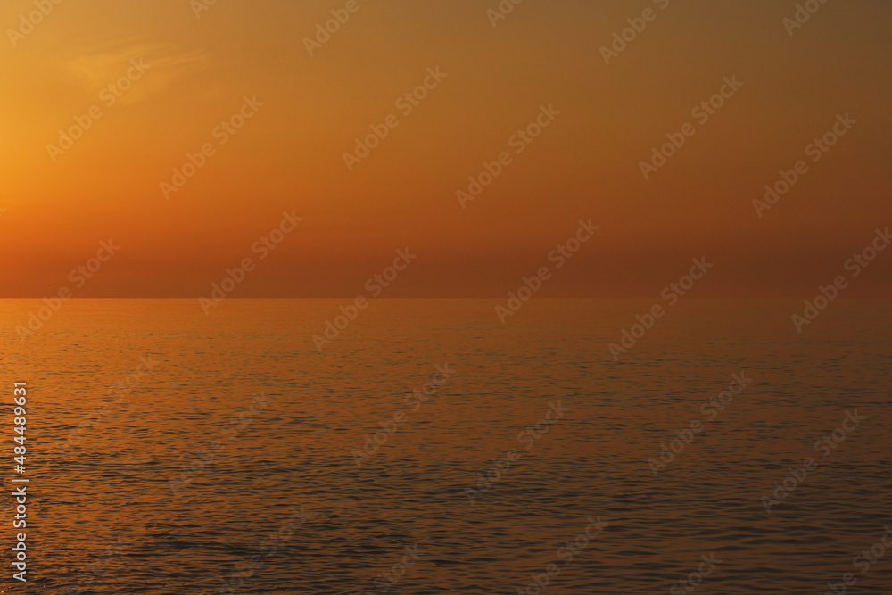 Dark orange colored sunset over the sea or ocean. For relax and anti stress