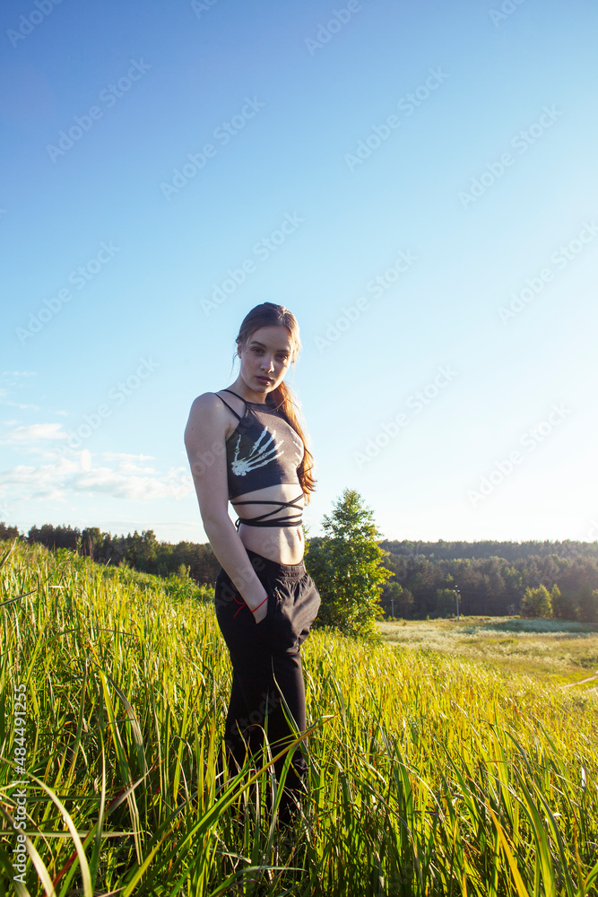 young pretty blond caucasian girl resting in green field at summer, lifestyle people concept young pretty blond caucasian girl resting in green field at summer, lifestyle people concept
