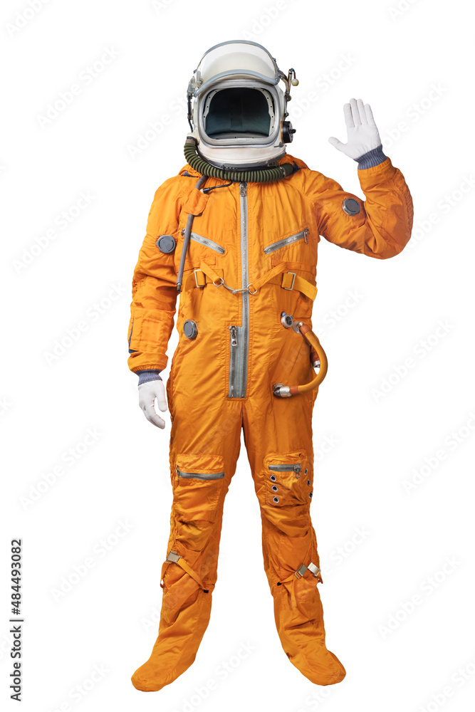 Astronaut wearing an orange spacesuit and helmet waives hand in hello gesture isolated over white background. Astronaut gesturing Hi greeting Astronaut wearing an orange spacesuit and helmet waives hand in hello gesture isolated over white background. Astronaut gesturing Hi greeting