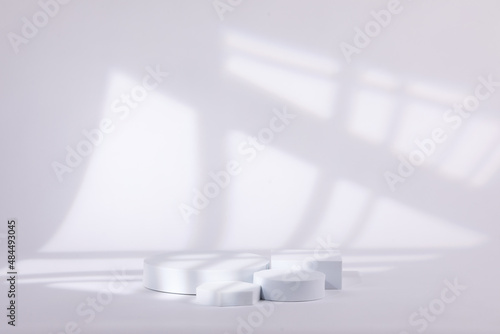 Gray background with a white shape with lines behind for product commercial.