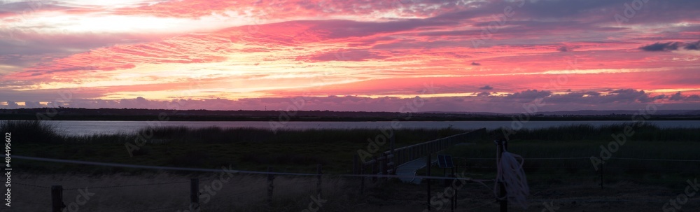 Panorama of jetty and spectacular sunset across river in rural farm in Clayton, South Australia. Panorama of jetty and spectacular sunset across river in rural farm in Clayton, South Australia.