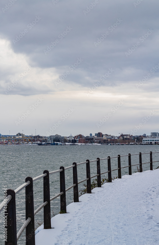 Urban pathway promenade with snow by the sea in winter cold day. Urban pathway promenade with snow by the sea in winter cold day.