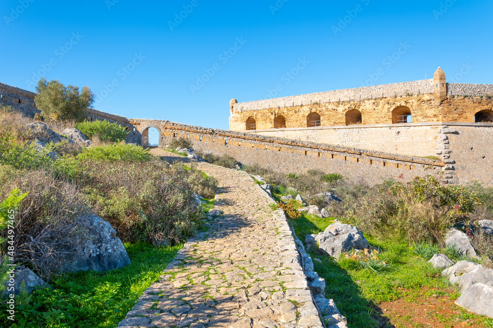 Walls and structures at the hilltop Fortress of Palamidi above the town of Nafplio in the Peloponnese region of Southern Greece on a clear summer day.