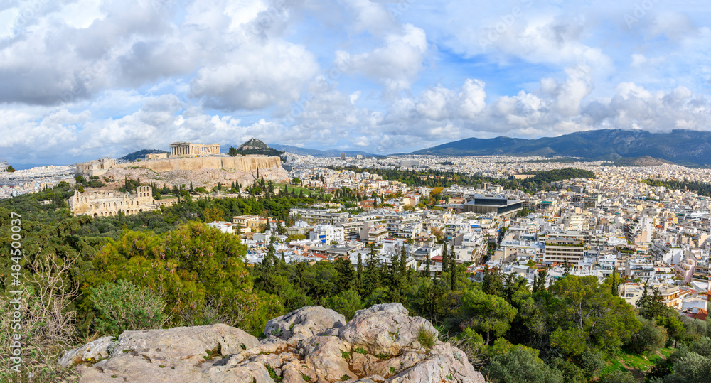 Panoramic view from the top of Filapappou or Philopappos Hill of the Parthenon and Erechtheion on Acropolis Hill, with Mount Lycabettus in the background in Athens, Greece	