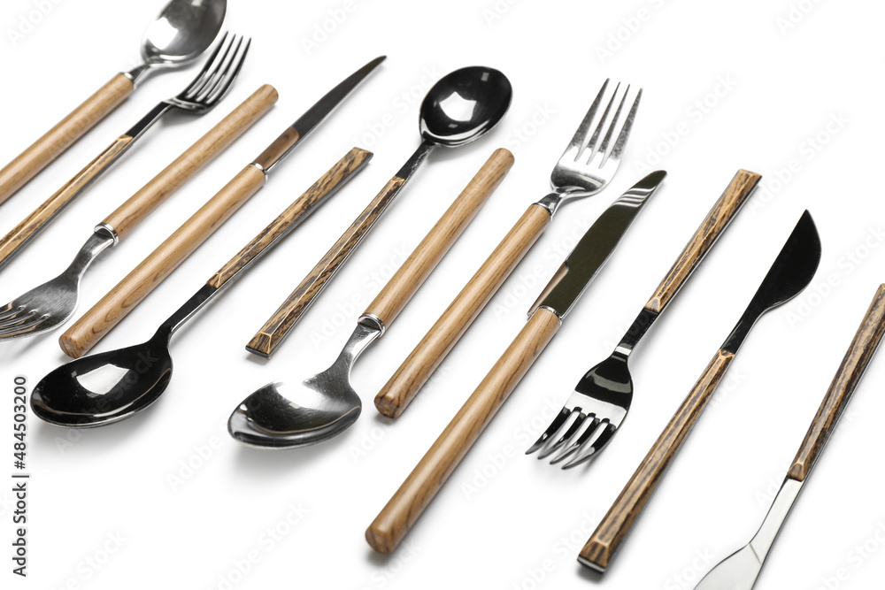 Fototapeta premium Set of stainless steel cutlery with wooden handles on white background