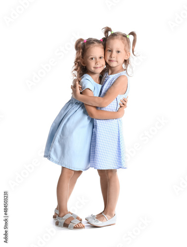 Adorable little sisters hug...