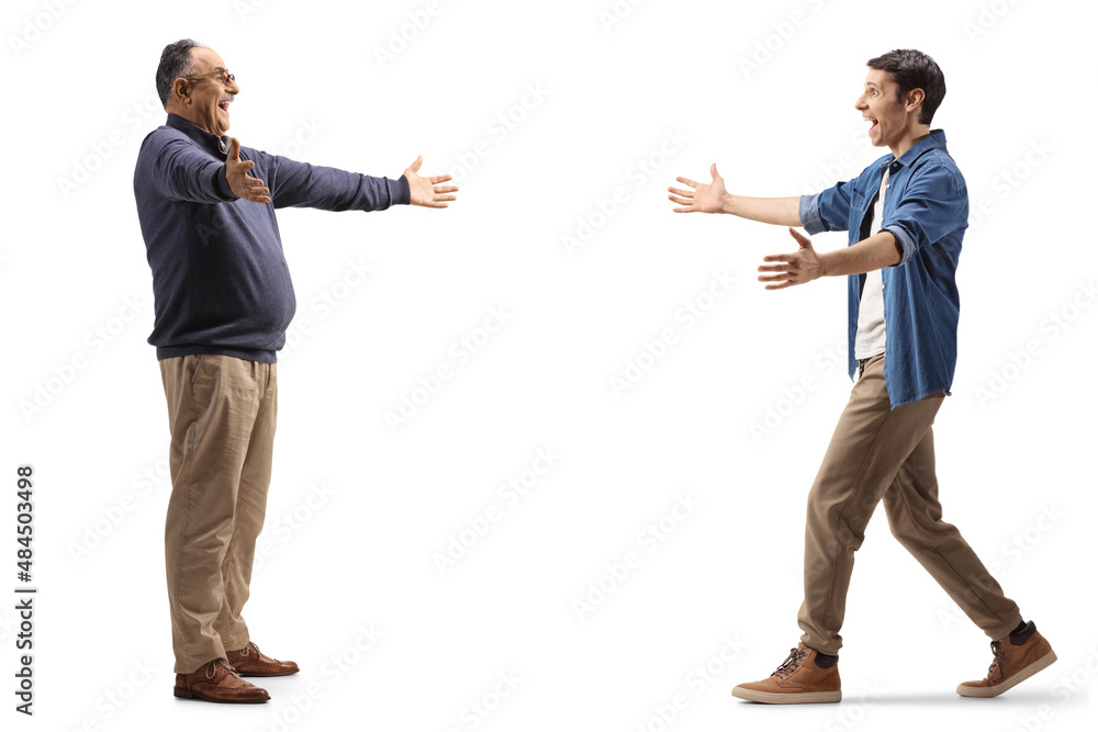 Full length profile shot of a mature and younger man greeting each other with arms wide open Full length profile shot of a mature and younger man greeting each other with arms wide open