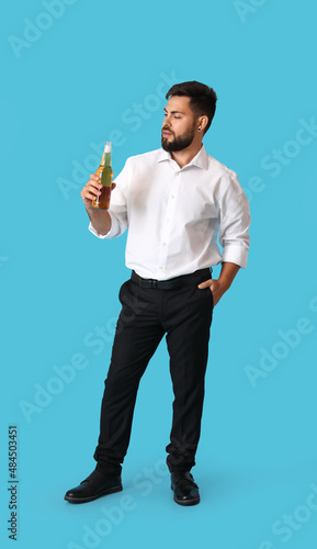 Young businessman with bott...