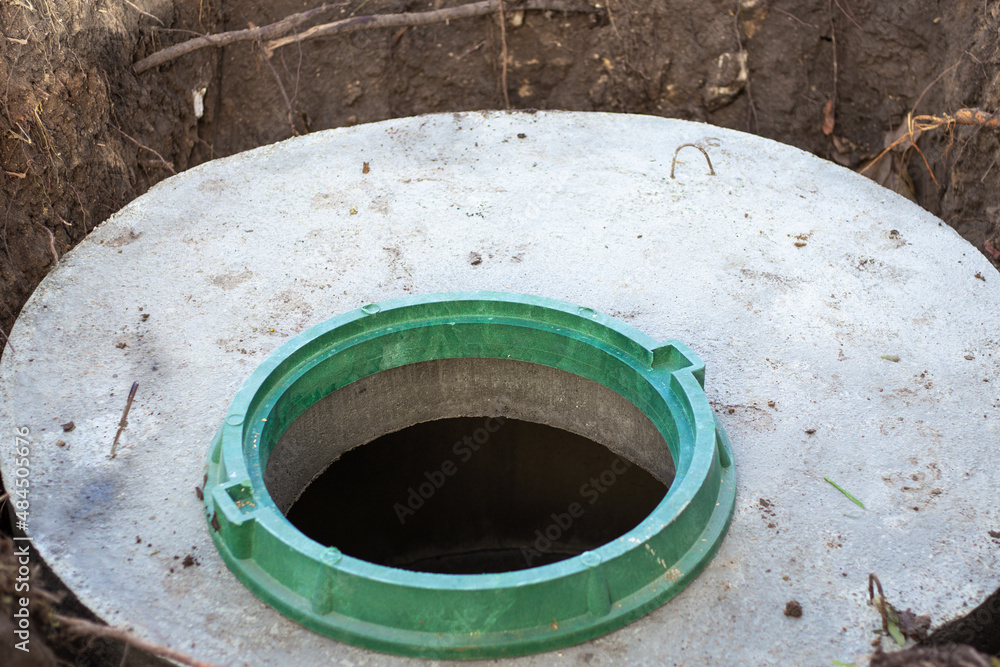 Sewer well open hatch. Water supply and sewerage construction Sewer well open hatch. Water supply and sewerage construction