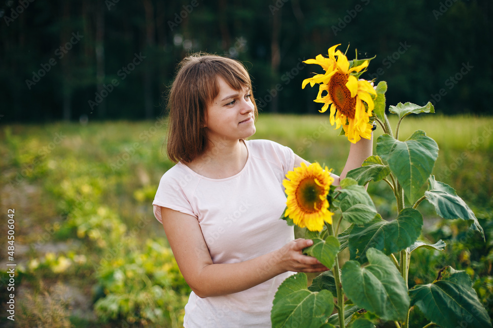 Beautiful girl and two lonely sunflowers in the field
Beautiful girl and two lonely sunflowers in the field