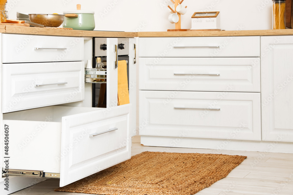 Opened drawers in light kitchen interior Opened drawers in light kitchen interior