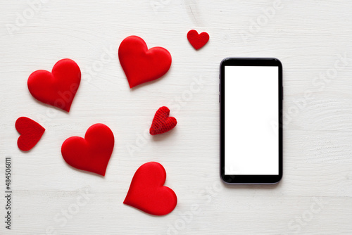 White wood background with tablet and hearts, love concept, romantic mock-up, st. Valentine's Day mock-up