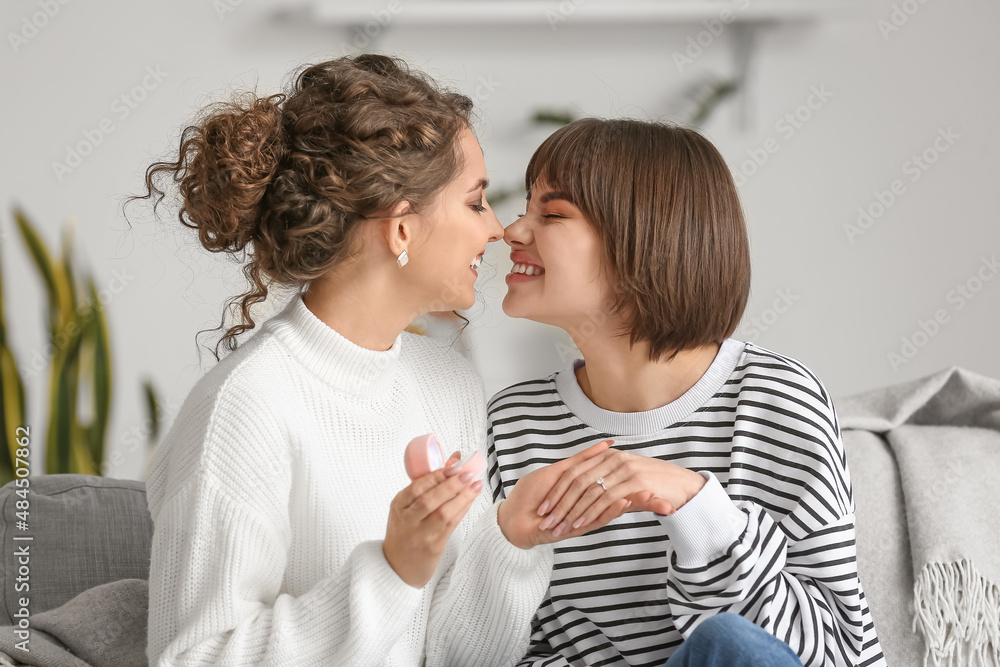 Happy engaged lesbian couple at home Happy engaged lesbian couple at home