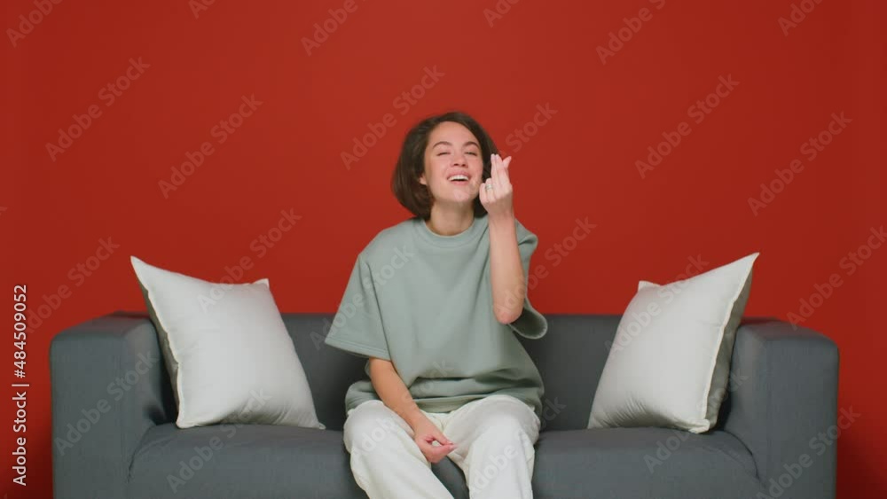Emotional beautiful girl shows money gesture. Not enough money. Debt or credit. Red background. Emotional beautiful girl shows money gesture. Not enough money. Debt or credit. Red background.
