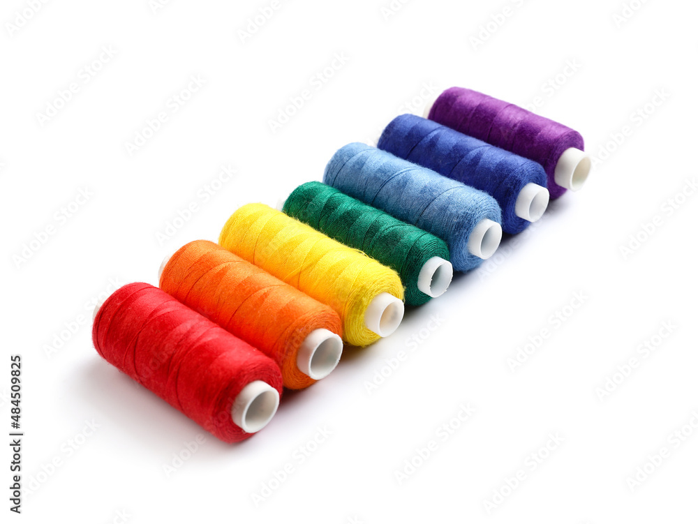 Beautiful sewing threads on white background Beautiful sewing threads on white background