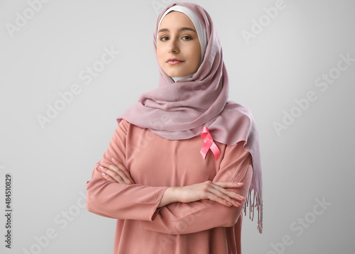 Muslim woman with pink ribb...