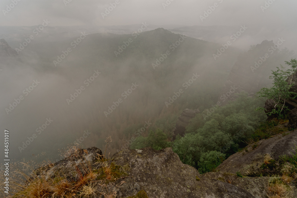 An early cloudy morning in mountain. Schrammsteine - group of rocks are a long, strung-out, very jagged in the Elbe Sandstone Mountains located in Saxon Switzerland in East Germany.