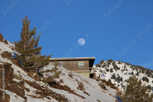 moon over house in the mountains