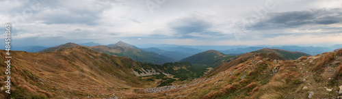 Panoramic mountain landscape. Cloudy sky. Mount Hoverla in the background. Chornohora mountain range. Western Ukraine.