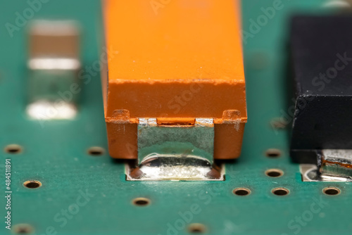 Close up shot of Tantalum capacitor on a printed circuit board photo