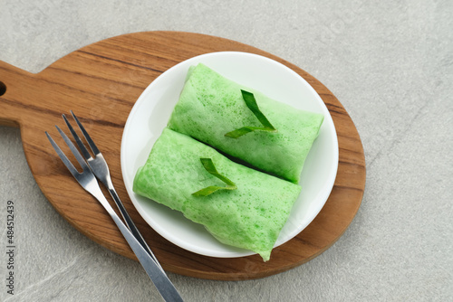 Kue dadar gulung (Sweet coconut pancake), Indonesian dessert made from flour with grated coconut mixed palm sugar. Selected focus. 