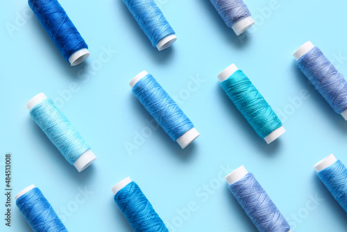 Thread spools on blue background