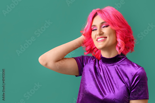 Stylish woman with bright hair on color background © Pixel-Shot