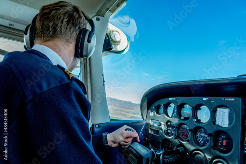 pilot at aircraft cockpit at a private flight above new zealand