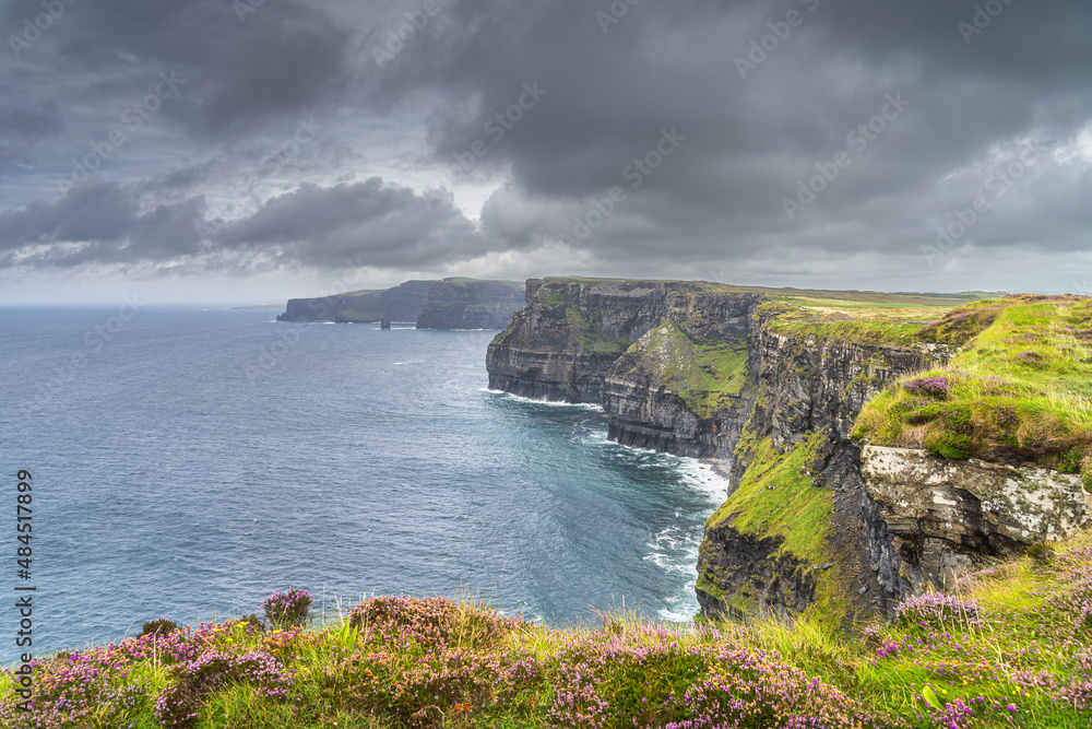 Dark, dramatic storm sky over iconic Cliffs of Moher, popular tourist attraction, UNESCO world heritage, Wild Atlantic Way, Clare, Ireland