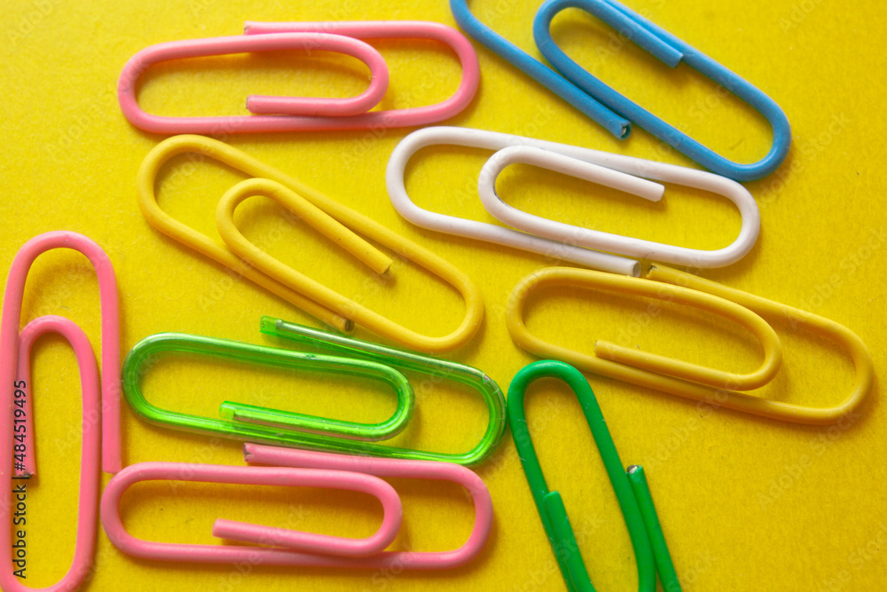 paper clips yellow background paper clips yellow background