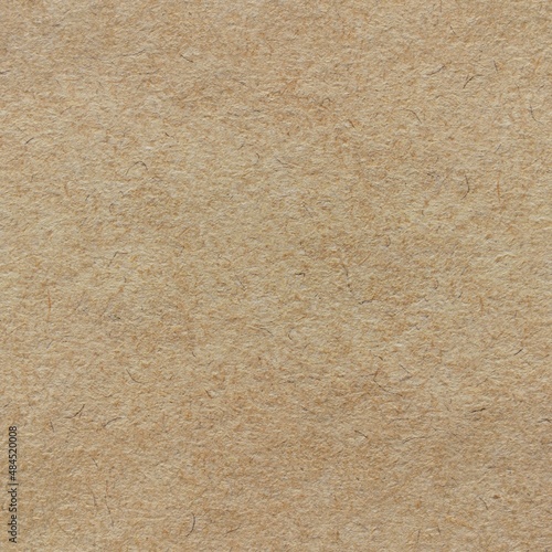 Brown fibril seamless recycled craft paper or cardboard texture as background