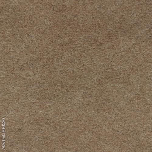 Dark brown recycled craft paper or cardboard texture as background