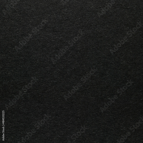 Black paper or cardboard texture as background