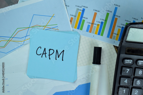 CAPM write on sticky notes isolated on Wooden Table.