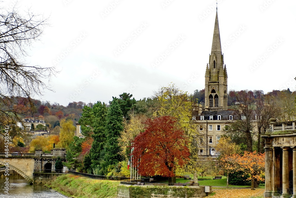 Georgian architecture surrounded by autumn foliage, on the bank of the River Avon in Bath, England
