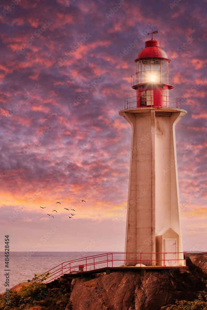 Beaming Lighthouse Under Dramatic Sunset Skies