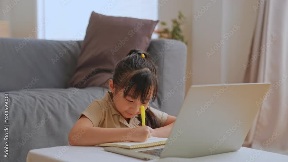 Curious cute preschool kid girl watching internet video course at home desk. back to School, Online learning, distance lesson, education at home, doing homework at home. Children tech addiction. Curious cute preschool kid girl watching internet video course at home desk. back to School, Online learning, distance lesson, education at home, doing homework at home. Children tech addiction.