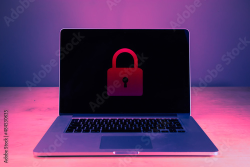 Laptop cyber security concept. Locked laptop screen. Secure personal information and data privacy. Red padlock on laptop screen. Hacking and login attempt.