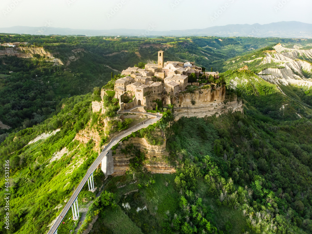 Aerial summer evening view of famous Civita di Bagnoregio town, beautiful place located on top of a volcanic tuff hill overlooking the Tiber river valley