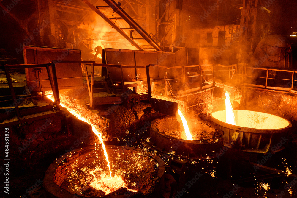 Blast furnace slag and pig iron tapping. Molten metal and slag are poured  into a ladle. Stock Photo | Adobe Stock