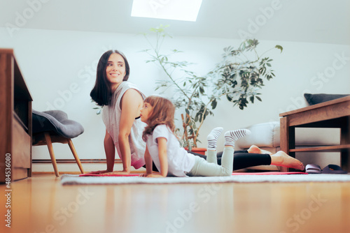 Mother and Daughter Exercising Together on a Yoga Mat
