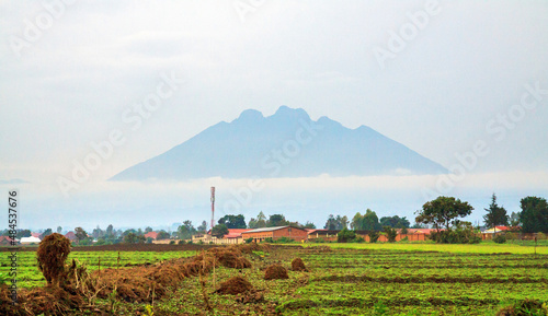 MUSANZE, RWANDA.  Mt Sabinyo volcano seen from the city of Musanze, former Ruhengeri, surrounded by morning mist. It stands at the border with DRC photo